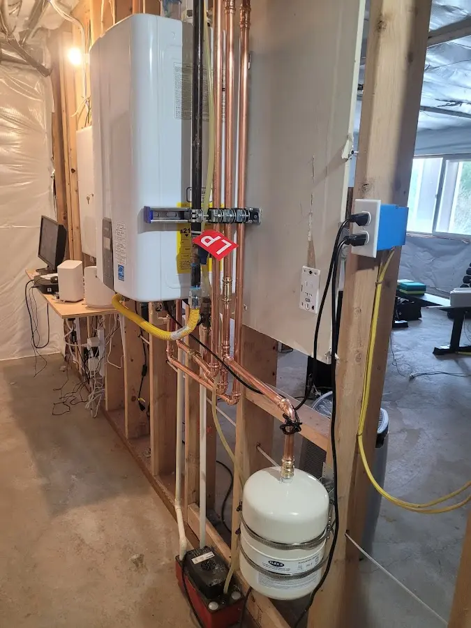 Licensed plumber repairing a kitchen sink in Malverne